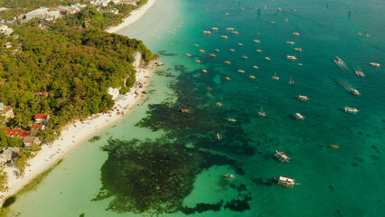 Tropical landscape boats in the turquoise lagoon and tropical beach from above. Seascape with beach...