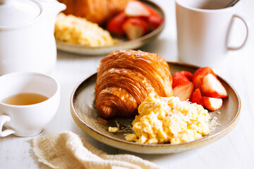 Croissant and scrambled egg breakfast
