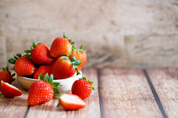 Fresh strawberries on wooden table.