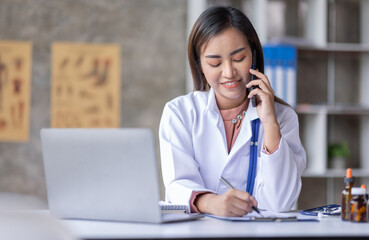 Young Asia Female  doctor talking on a cellphone in a modern office