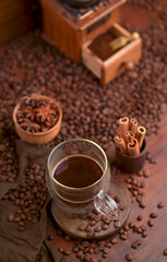 Cup Of Coffee And Coffee Beans On Table.