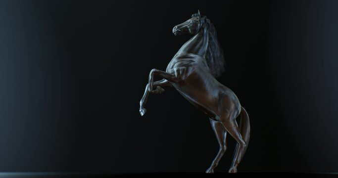 Dark stallion rearing up and starting to run against black background with side light on body, horse animation