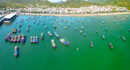 Fototapeta na wymiar Vinh Luong fishing village, Nha Trang, Vietnam seen from above with hundreds of boats anchored to avoid storms, traffic and densely populated areas below