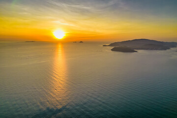 Obraz premium Aerial view of sunrise offshore as the sun rises to welcome a new day in the central coast of Vietnam