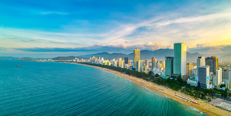 Fototapeta premium The coastal city of Nha Trang, Vietnam seen from above in the afternoon with its beautiful city and clean sandy beach attracts tourists to visit