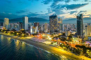 Fototapeta na wymiar The coastal city of Nha Trang, Vietnam seen from above in the afternoon with its beautiful city and clean sandy beach attracts tourists to visit