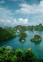 Fototapeta na wymiar Stunning vertical aerial view of rock formations and boats in Ha Long Bay, Vietnam