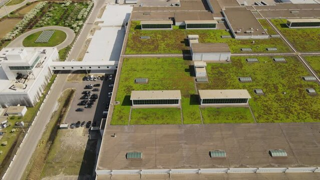 Aerial Tucking shot of Ford Rouge Electric Vehicle Center with a green roof, Assemble the new F150 Lightening