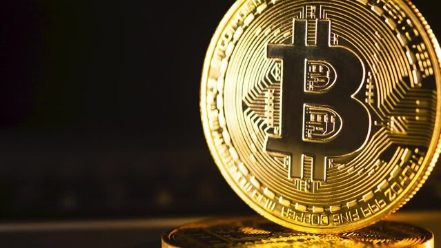 Gold Bitcoins in Black Background. Value Concept