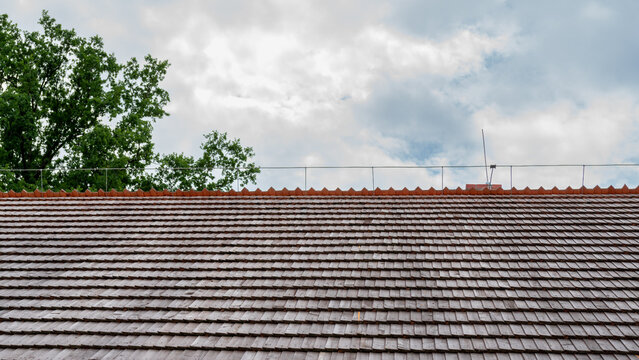 Shingled roof with a lightning protection system on the ridge. Polish traditional house