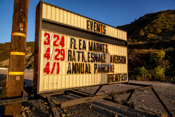 Obraz premium Quaint Small Town Sign with Event List such as pancake breakfast