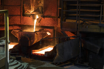 Process of pouring liquid hot copper into molds.