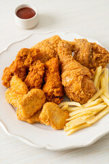 fried chicken with french fries and nuggets on plate