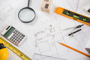 Architectural project workplace. Top view of house plan blueprint paper with repair tools on table desk at architecture office, Engineering architect design tools concept