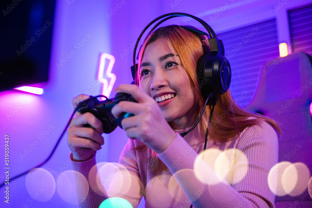 Poster you win. gamer using joystick controller plays online video game with computer neon lights very dete