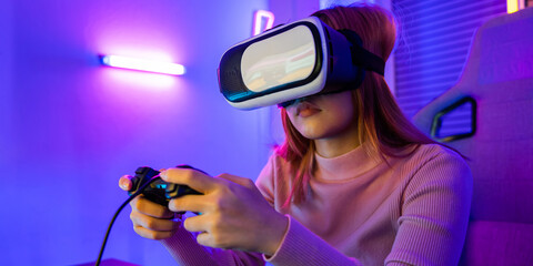 Excited woman virtual playing gamepad controller she very determined at home, Gamer in VR headset...