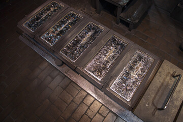 Molds with solidifying hot silver.