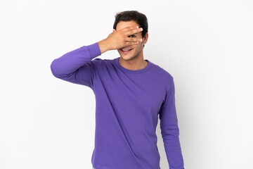 Caucasian handsome man over isolated white background covering eyes by hands and smiling