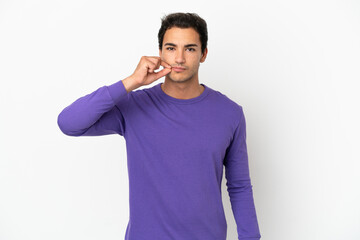 Caucasian handsome man over isolated white background showing a sign of silence gesture