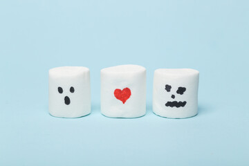 Marshmallow with red heart in toilet miniature on blue background