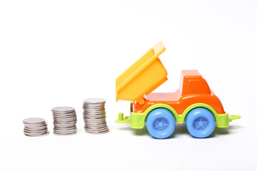 Truck with stack of coins on white background