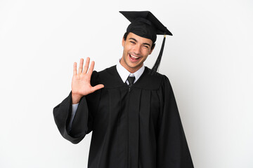 Young university graduate over isolated white background saluting with hand with happy expression