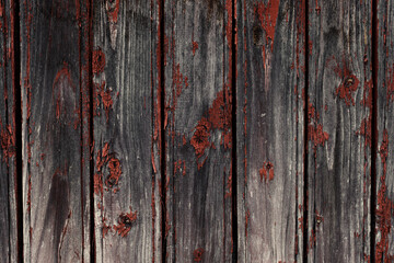 Old natural weathered wooden planks with cracked red paint background