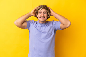 Fototapeta na wymiar Handsome blonde man isolated on yellow background doing nervous gesture