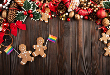 Christmas background of gingerbread cookie men with rainbow flags on wooden table