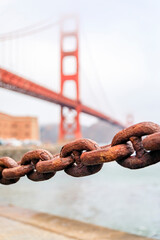 Blurred Golden Gate bridge with a rusty old chain in San Francisco, California
