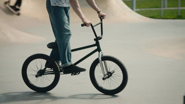 Urban youth extreme culture. Bicycle stunts in the city skate park.