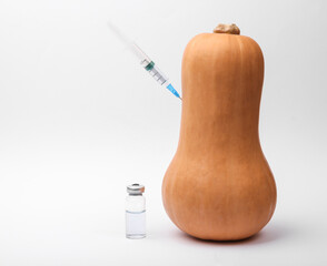 Pumpkin with a syringe on a white background. Vaccination
