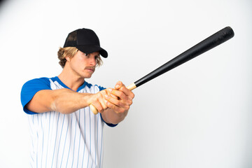 Young blonde man isolated on white background playing baseball