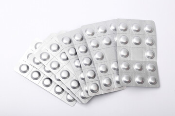 Metal blisters of pills on a white background