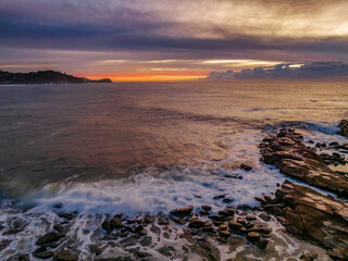 Sunrise over the sea with high cloud filled sky