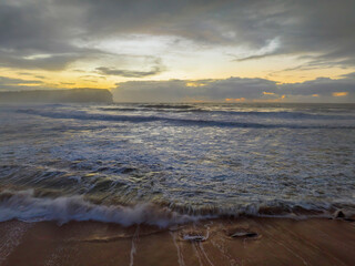 Sunrise at the seaside with large and powerful sets