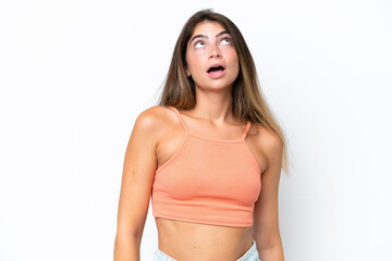 Fototapeta premium Young caucasian woman isolated on white background looking up and with surprised expression