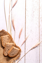Bread ears and pieces of bread on a burlap on the table, a place for the text