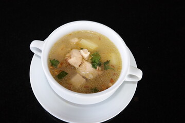 delicious and healthty chicken soup in a white bowl