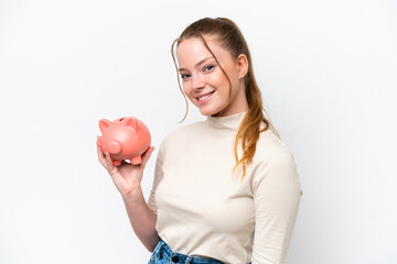 Young caucasian girl holding a piggybank isolated on white background smiling a lot