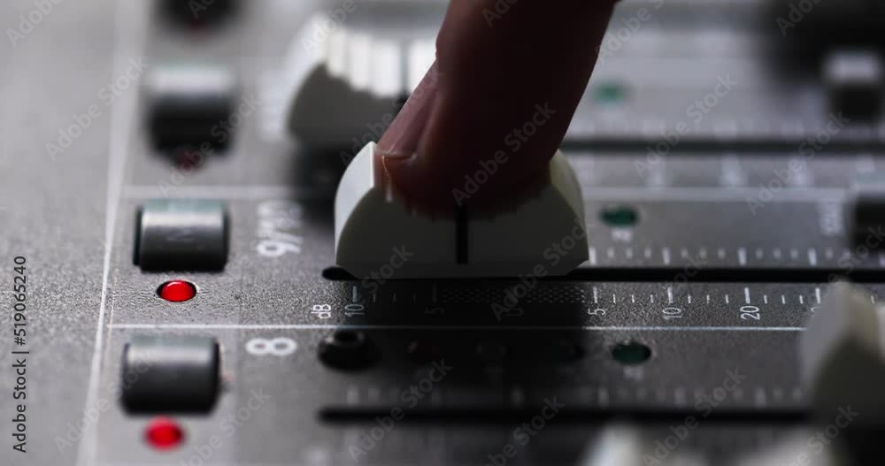 Poster person's index finger slide up the fader to the maximum volume of mixing console. - close up