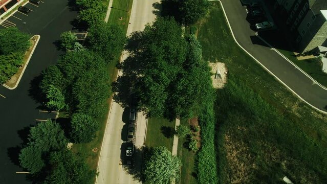 car hauler hotshot pickup truck driver is driving on road and hauling 3 cars drone footage 4k