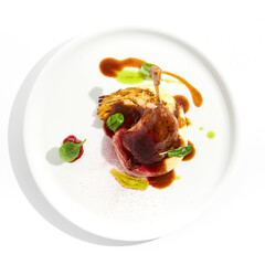Delicatessen dish - duck leg confit with mashed potatoes and cabbage steak. Duck confit with vegetables and wine gravy on white plate. Gourmet meal in restaurant menu. Fusion main course.