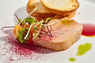Chicken liver pate with toasted bread and jam isolated on white background. Meat terrine with citrus and toast. Restaurant food - duck pate with baguette on white plate. Meat appetizer.