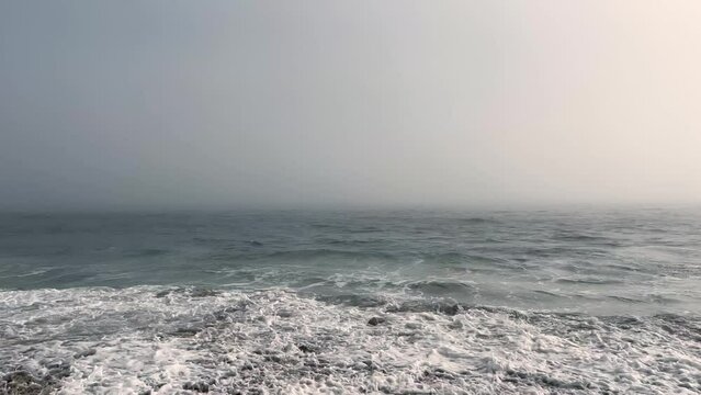 4k Malibu Beach Blue and Green Ocean waves crash into the shore on a cloudy day b roll