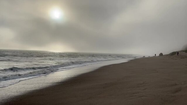 4k Malibu Beach Blue and Green Ocean waves crash into the shore on a cloudy day b roll