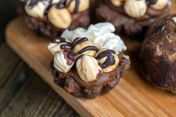 multicomponent cake made of caramel and nuts in chocolate