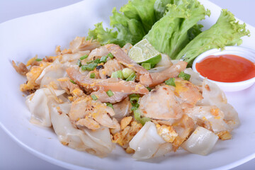 Stir fried Chicken Noodles and egg on white bowl for Thai food and isolate background 