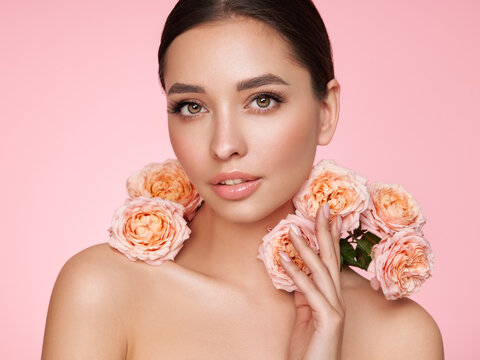Portrait beautiful young woman with clean fresh skin. Model with healthy skin, close up portrait. Cosmetology, beauty and spa. Girl with a rose flower