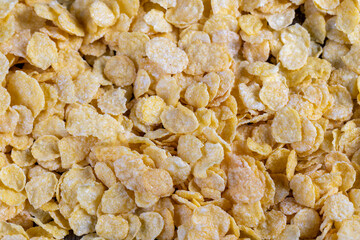 dry breakfast corn flakes of yellow color , close up
